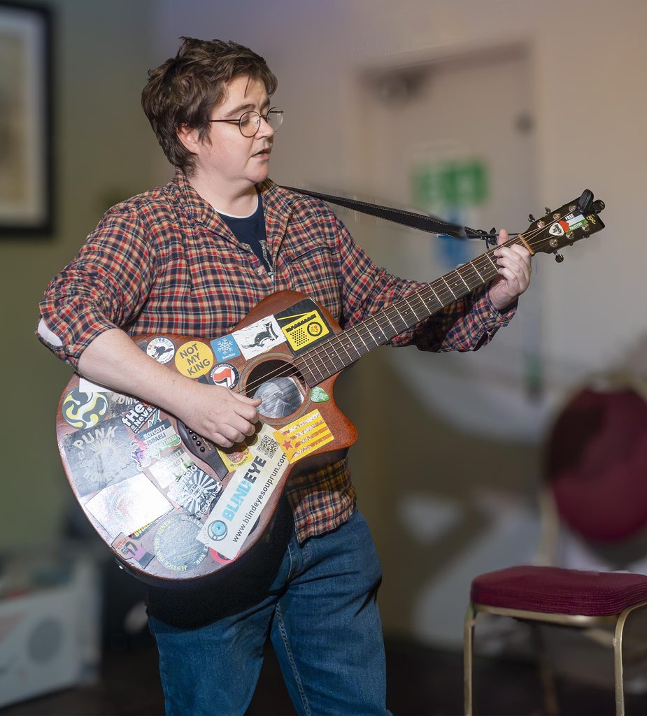 Sarah Farrell playing guitar